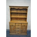 A PINE DRESSER, with six drawers, and double panelled doors, width 122cm x depth 46cm x height 192cm