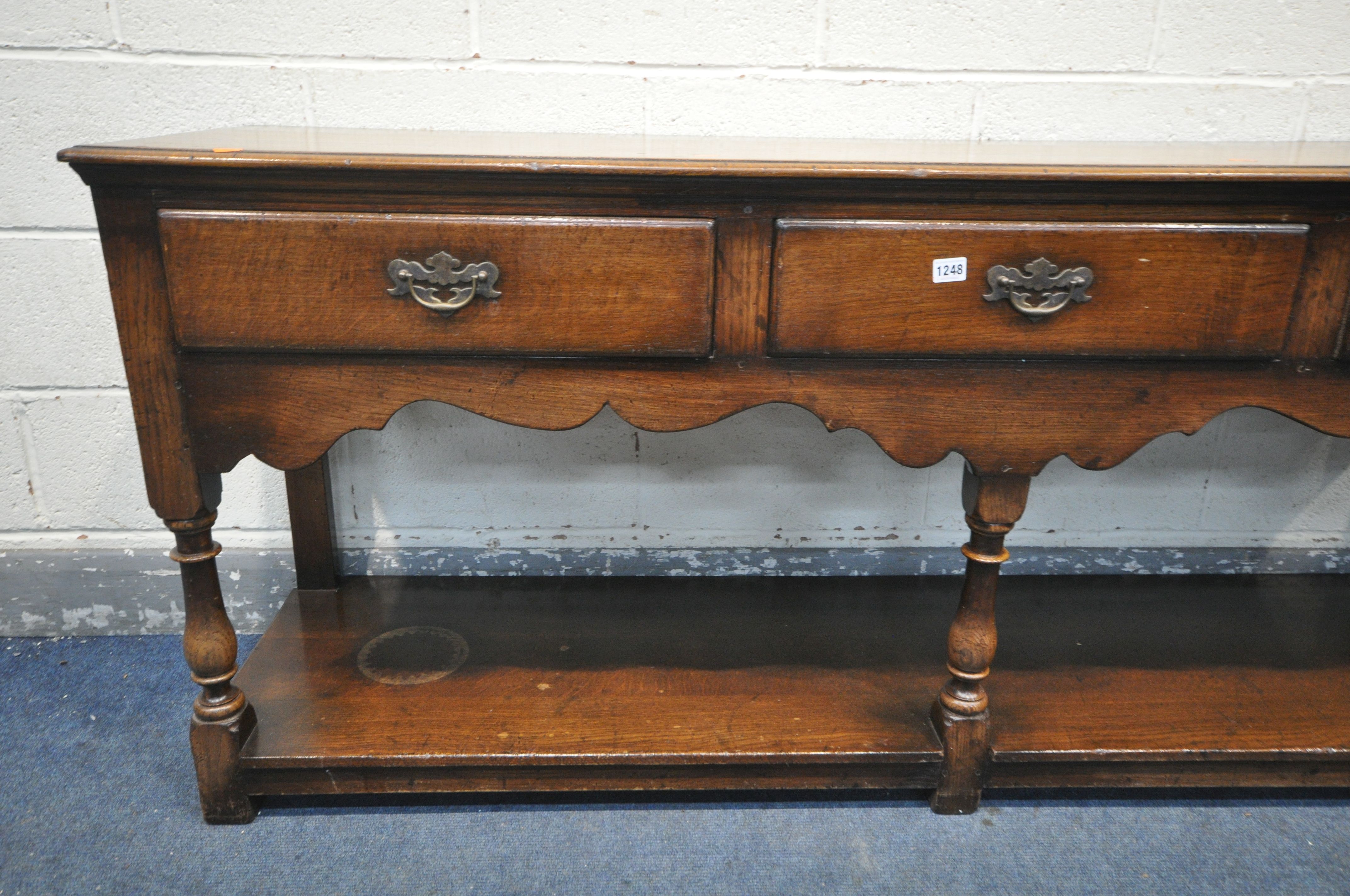 A REPRODUCTION OAK DRESSER BASE, with three frieze drawers, on turned front legs, united by an under - Image 3 of 3