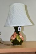 A MOORCROFT POTTERY TABLE LAMP, decorated in the Coral Hibiscus pattern on a green ground, with a