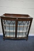 A 20TH CENTURY OAK GLAZED TWO DOOR DISPLAY CABINET, with a raised back, two fixed shelves, on