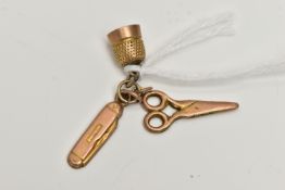 A YELLOW METAL CHARM, a rolled gold charm suspending a pair of scissors, thimble and pen knife,