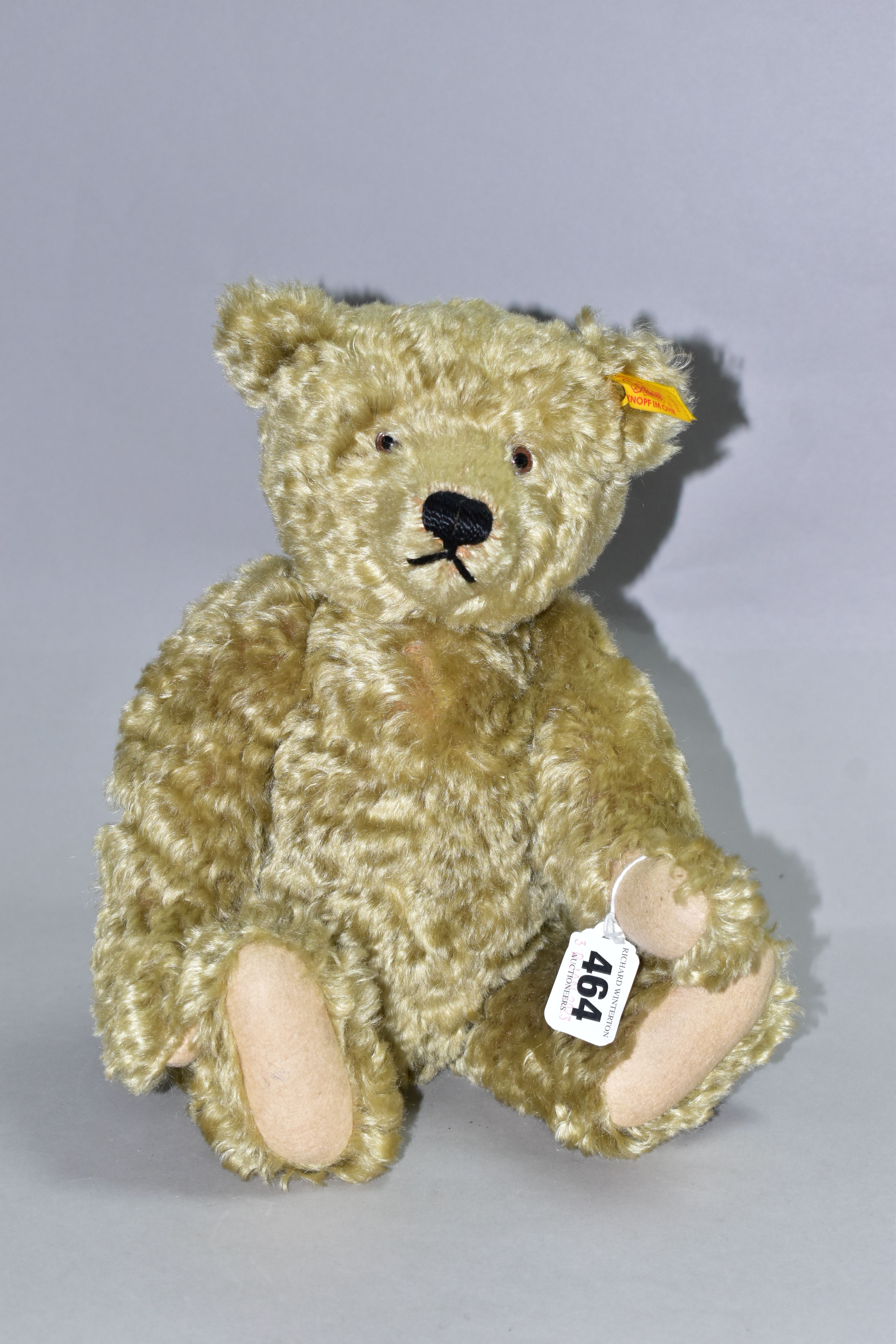 A MODERN STEIFF BLONDE PLUSH MOHAIR TEDDY BEAR, No.654466, button and yellow tag to left ear,