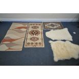 A SELECTION OF RUGS, to include two sheepskin rugs, and three other modern rugs (5)