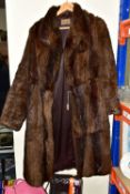 A SILVER LYS SUITCASE ON WHEELS AND A FUR COAT, comprising a vintage dark brown full length Coney
