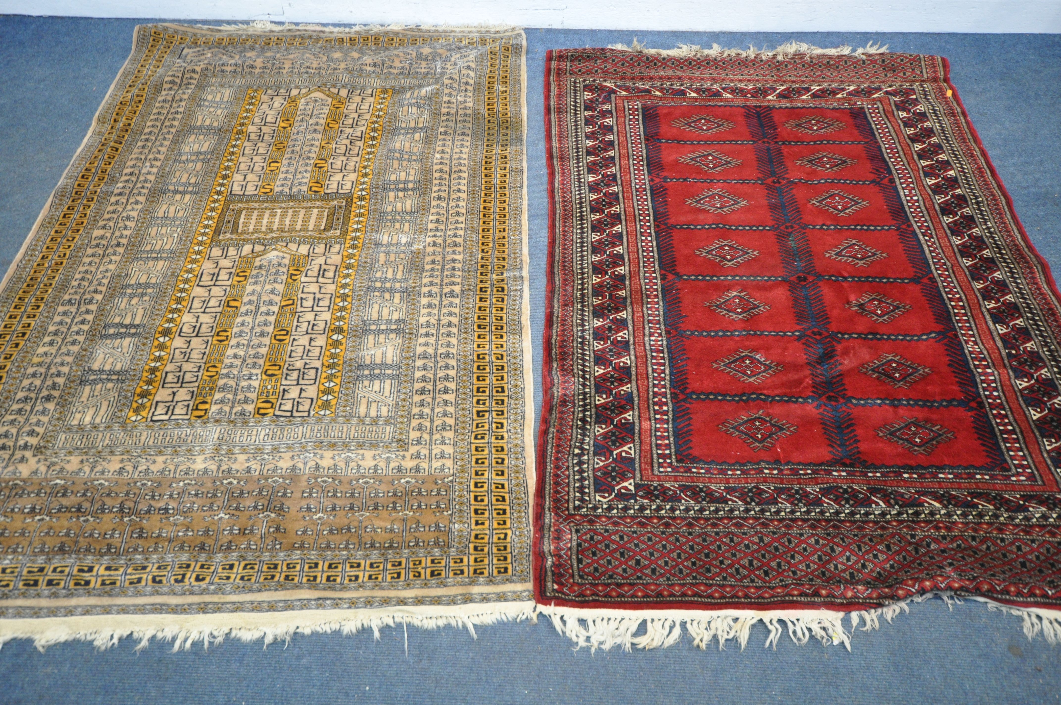 TWO 20TH CENTURY WOOLLEN RUGS one with red field 186cm x 124cm and the other russet coloured,