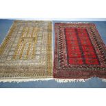TWO 20TH CENTURY WOOLLEN RUGS one with red field 186cm x 124cm and the other russet coloured,