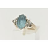 AN 18CT WHITE GOLD AQUAMARINE AND DIAMOND DRESS RING, set with an oval cut aquamarine, with