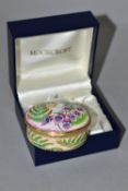 A BOXED MOORCROFT ENAMEL TRINKET BOX, of oval form, decorated in the 'Foxgloves' pattern, with