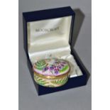 A BOXED MOORCROFT ENAMEL TRINKET BOX, of oval form, decorated in the 'Foxgloves' pattern, with