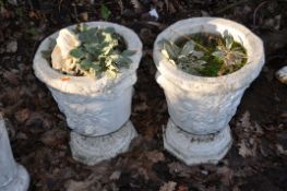 A PAIR OF TWO PIECE COMPOSITE GARDEN URNS with foliate detail to bowl height 50cm