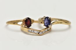 THREE 9CT GOLD GEM SET RINGS, the first designed with a four claw set, oval cut tanzanite, flanked