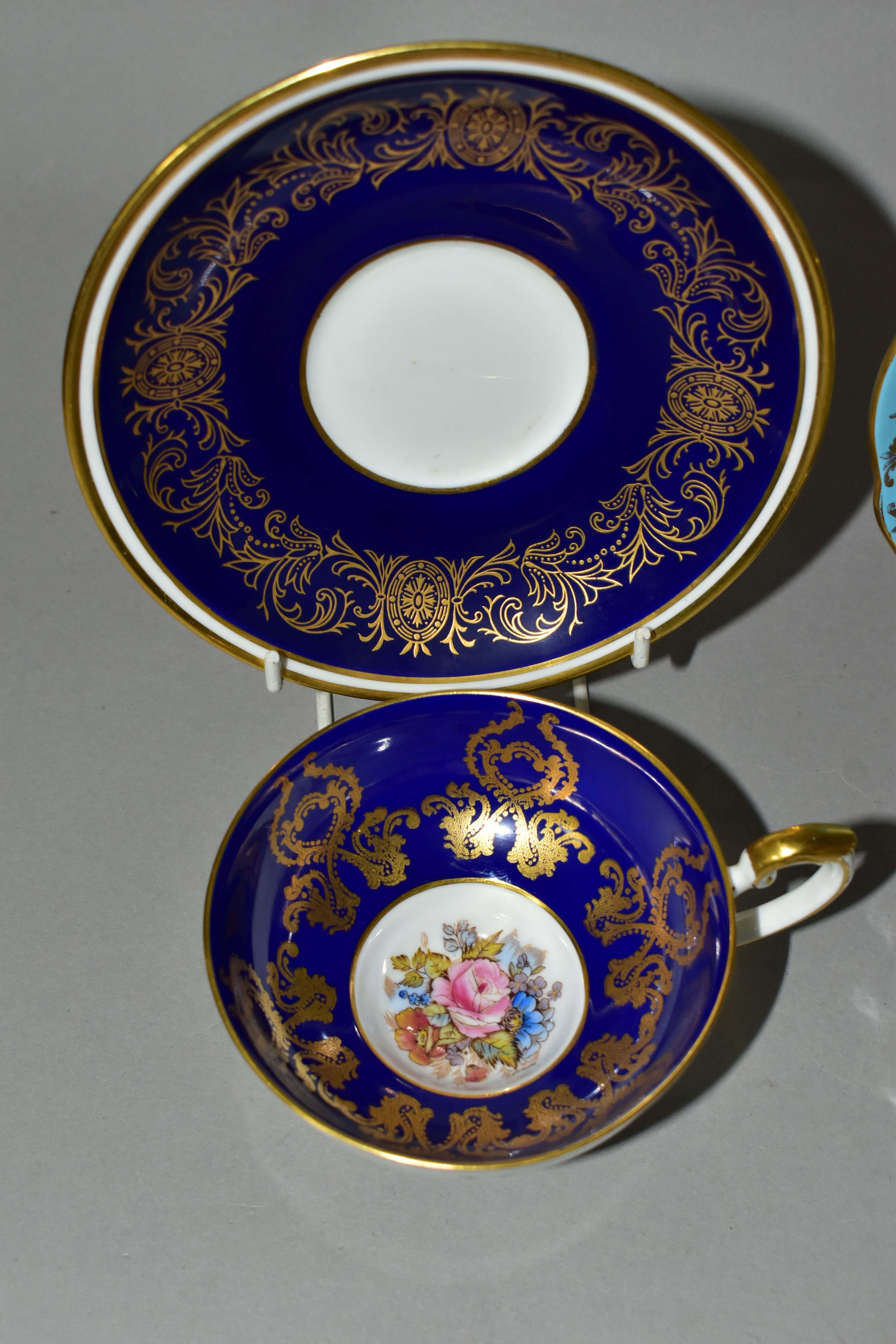 TWO AYNSLEY CABINET TEACUPS AND SAUCERS, comprising a turquoise cup and saucer, the interior of - Image 2 of 8