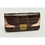 AN EARLY 20TH CENTURY CROCODILE SKIN PURSE, mounted with two 9ct rose gold hard wear corners to