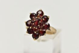 A 9CT YELLOW GOLD GARNET CLUSTER RING, of a marquise shape outline set with marquise and circular