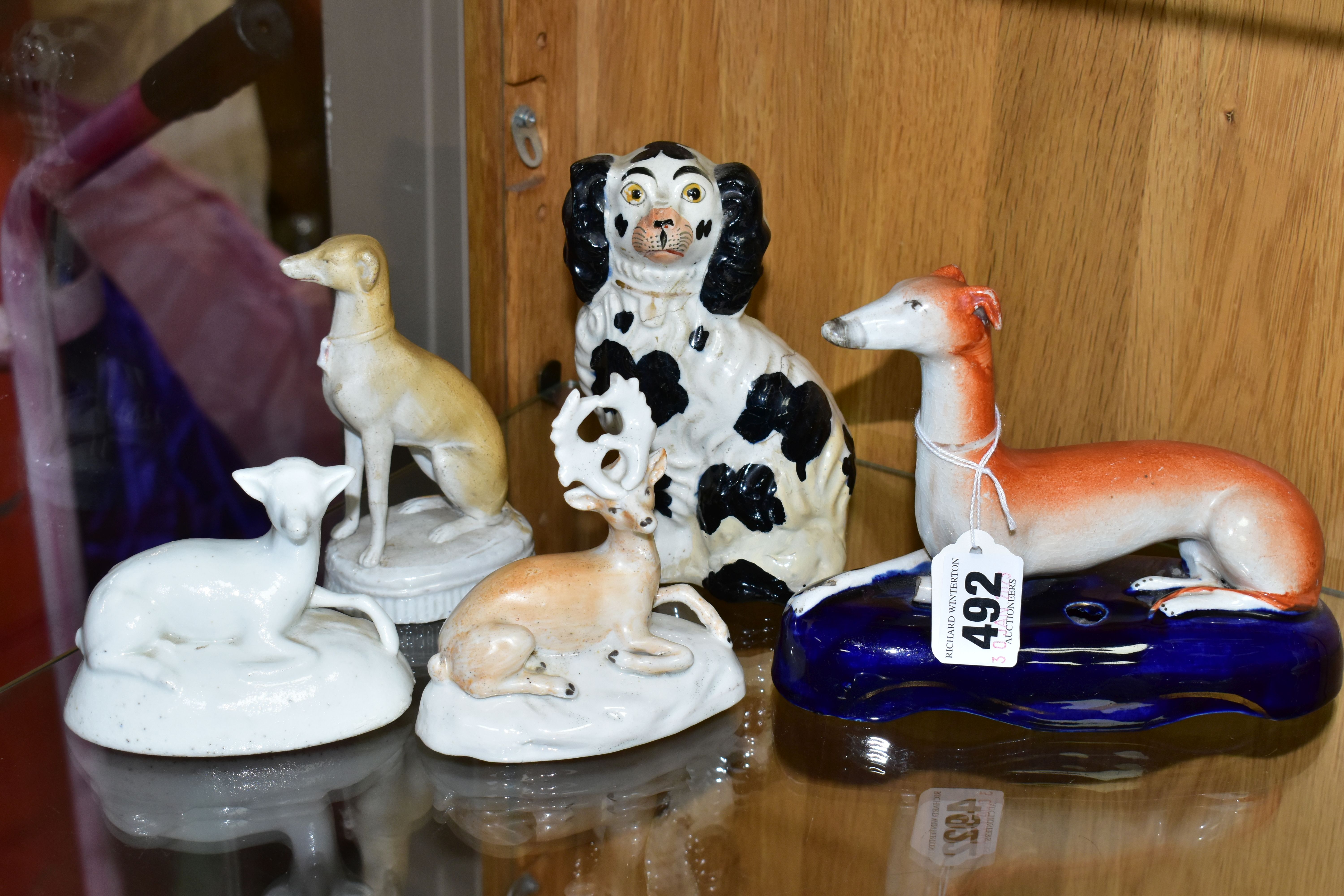 A GROUP OF LATE 19TH CENTURY STAFFORDSHIRE ANIMAL FIGURES, comprising a recumbent Greyhound pen