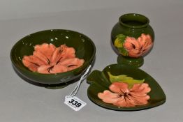 A MOORCOFT THREE PIECE SET, comprising a small pedestal dish, diameter 14cm, a bud vase, height 9cm,