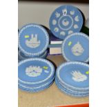 TWENTY ONE WEDGWOOD BLUE JASPERWARE CHRISTMAS CABINET PLATES, comprising plates from 1969 - 1988