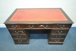 A 20TH CENTURY MAHOGANY PEDESTAL DESK, with red and tooled leather writing surface, and eight