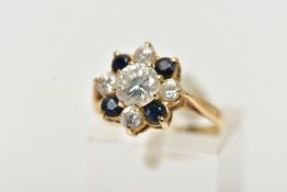 A 9CT YELLOW GOLD CUBIC ZIRCONIA AND SAPPHIRE CLUSTER RING, the principal colourless cubic