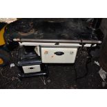 AN ANTIQUE ENAMELLED IRON COAL STOVE with floral design and flue