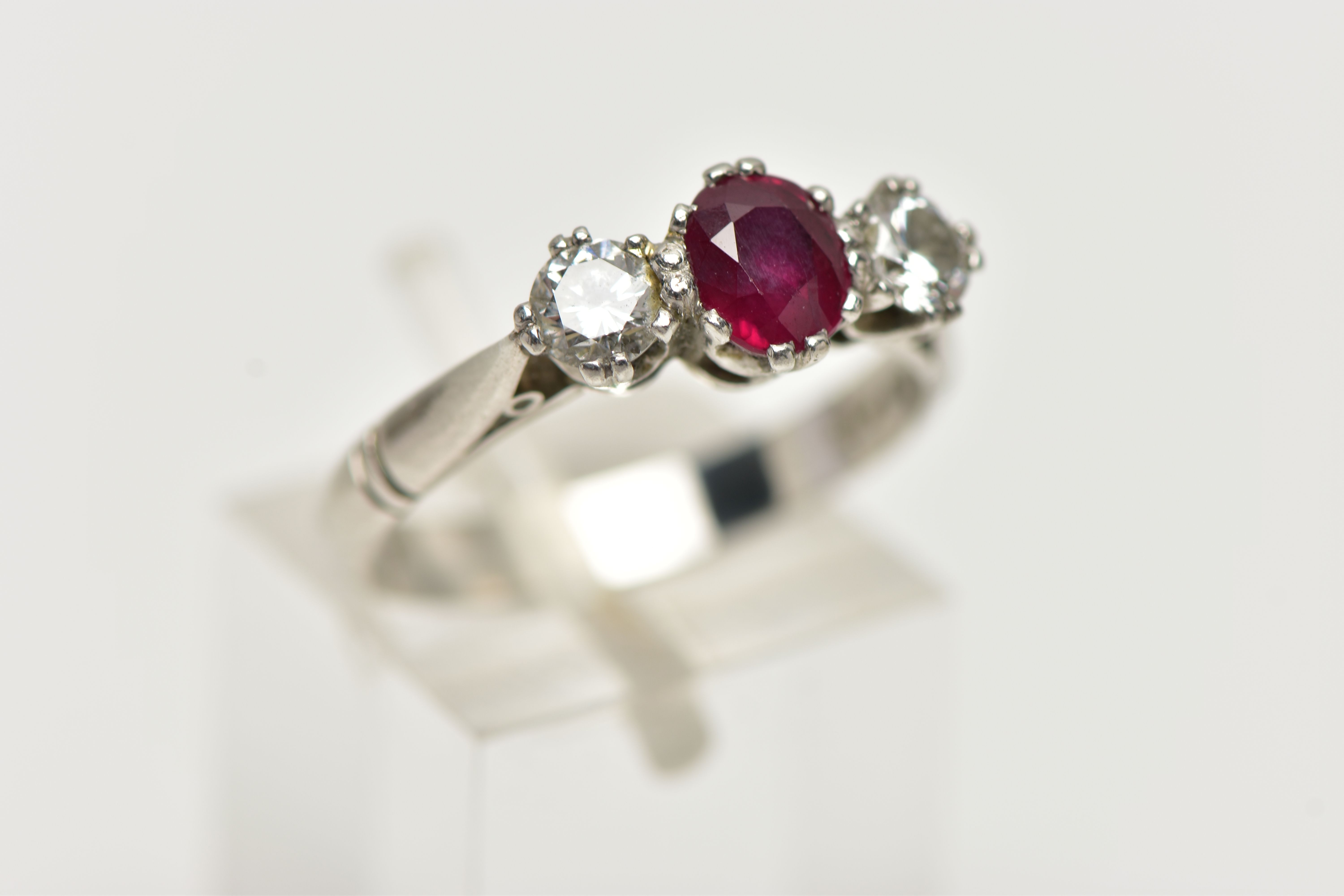 A PLATINUM RUBY AND DIAMOND THREE STONE RING, centering on an oval cut ruby, - Image 4 of 4