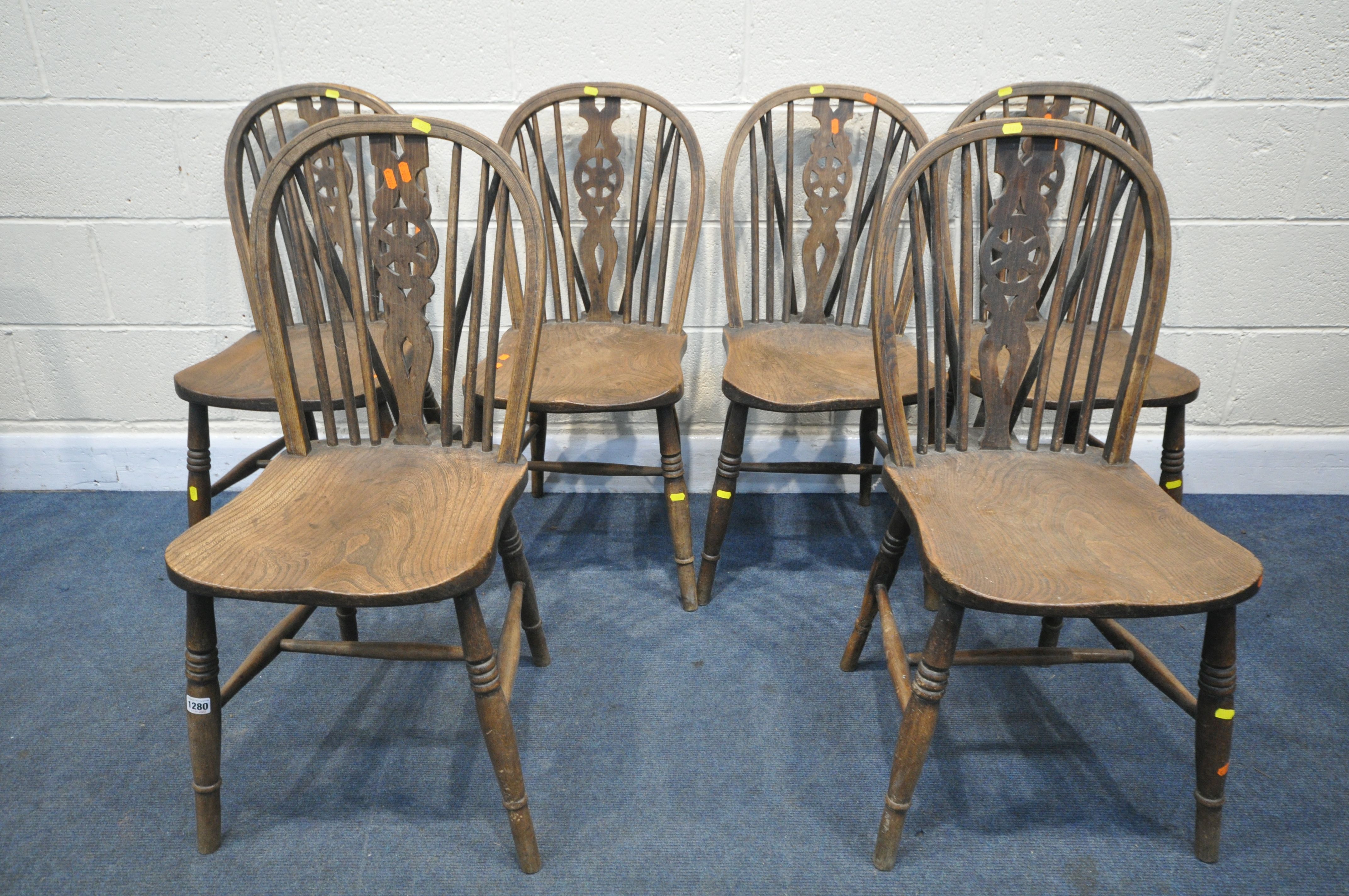 A SET OF SIX 19TH CENTURY ELM AND BEECH WHEELBACK CHAIRS (condition:-historical woodworm, some