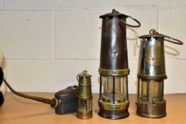 THREE MINERS' LAMPS AND AN OIL CAN, comprising a lamp by John Davis and Son, Derby, having brass