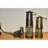 THREE MINERS' LAMPS AND AN OIL CAN, comprising a lamp by John Davis and Son, Derby, having brass