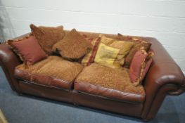 A RED LEATHER THREE SEATER SOFA, with scatter cushions, length 220cm (condition:-stain to left arm)