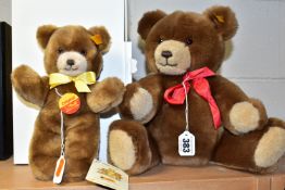 TWO STEIFF BEARS, comprising a boxed light brown bear 023132 with yellow ribbon, gold button, yellow