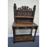 A LATE 19TH/EARLY 20TH CENTURY CARVED OAK SIDE TABLE, the raised back with a single shelf, depicting