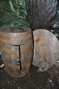A COOPERED OAK BAERRELL WITH WRAUGHT IRON BANDING with double doors - converted to pub/garden