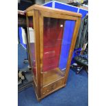 AN ART DECO WALNUT SINGLE DOOR CHINA CABINET, enclosing two glass shelves, width 70cm x depth 38cm x