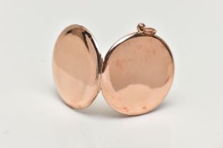 A ROSE TONE LOCKET, of a circular polished form, opens to reveal a glass covered vacant photo