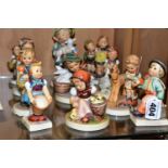 A GROUP OF ELEVEN HUMMEL GOEBEL PORCELAIN FIGURES, comprising 'Little Helper' 75, 'School Boy'