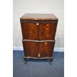 AN EARLY 20TH CENTURY MAHOGANY FOUR DOOR CABINET, on cabriole legs, with ball and claw feet, the top