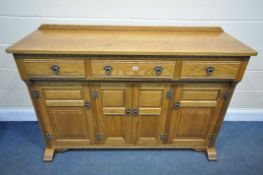 AN OLD CHARM OAK SIDEBOARD, with three drawers, over four cupboard doors, width 153cm x depth 48cm x