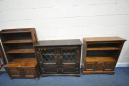 AN EARLY 20TH CENTURY OAK OPEN BOOKCASE, on a double cupboard door base, and casters, width 86cm x