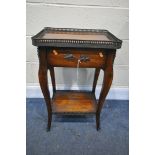 IN THE STYLE OF THEODORE ALEXANDER, A MAHOGANY SIDE TABLE, with a pierced brass gallery, a single