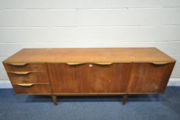 A MCINTOSH TEAK SIDEBOARD, with three drawers and a fall front door, enclosing a white Formica