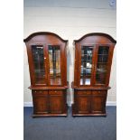 TWO HARDWOOD GLAZED TWO DOOR DISPLAY CABINETS, with two drawers, on double cupboard doors, width