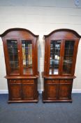 TWO HARDWOOD GLAZED TWO DOOR DISPLAY CABINETS, with two drawers, on double cupboard doors, width