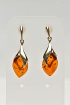 A PAIR OF 9CT GOLD, AMBER DROP EARRINGS, each designed as an oval amber drop in a yellow gold mount,