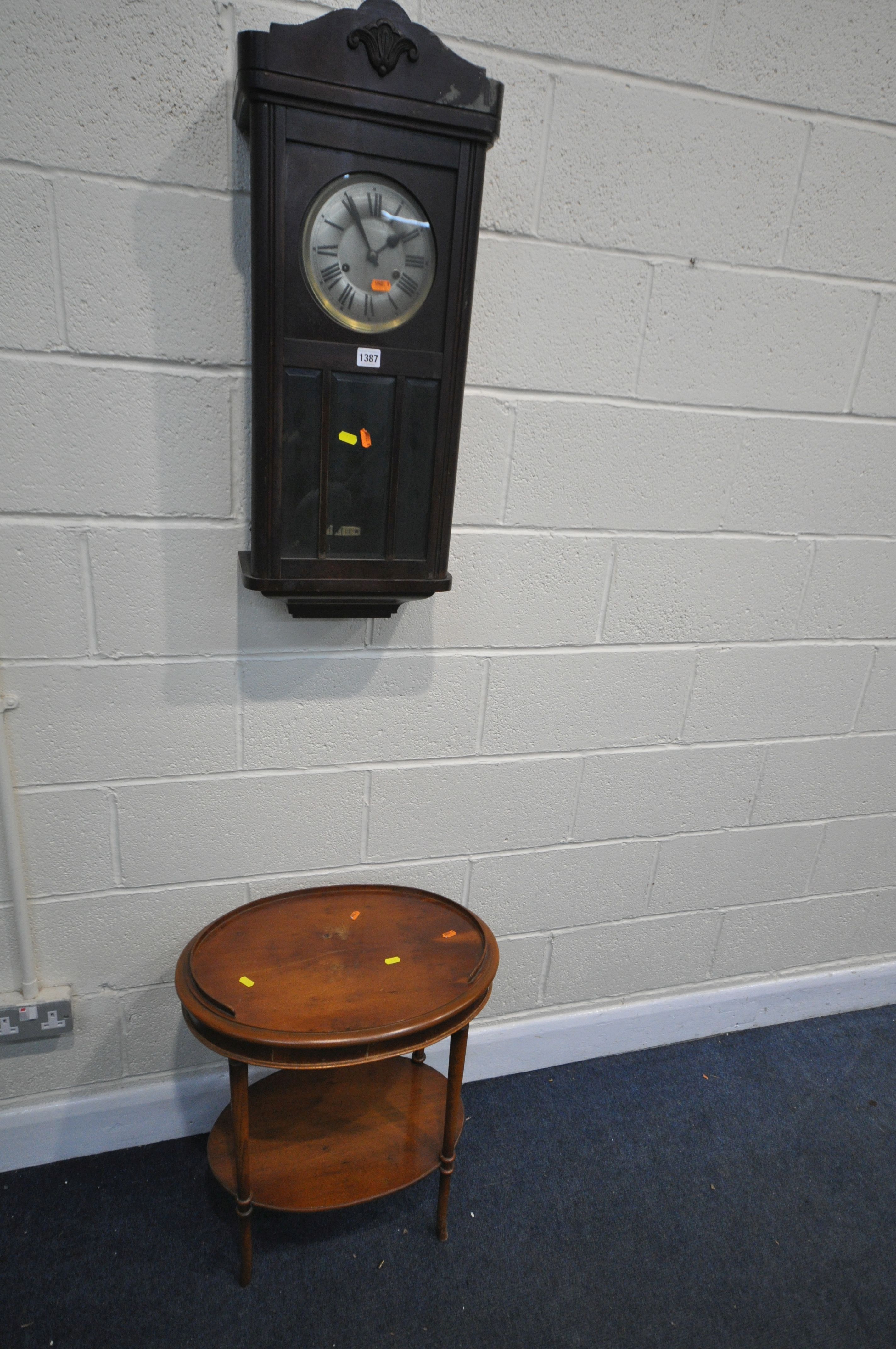 AN EARLY TO MID 20TH CENTURY OAK WALL CLOCK, with winding key and pendulum, along with a yew wood