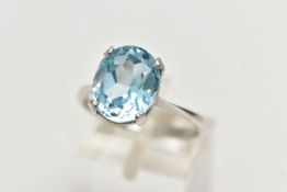 A MODERN 18CT GOLD TOPAZ RING, an oval cut light blue topaz, approximate dimensions length 12mm x