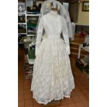 A VINTAGE WEDDING DRESS, ivory 1950s style, long sleeves with tapered cuffs, high neck, ribbon