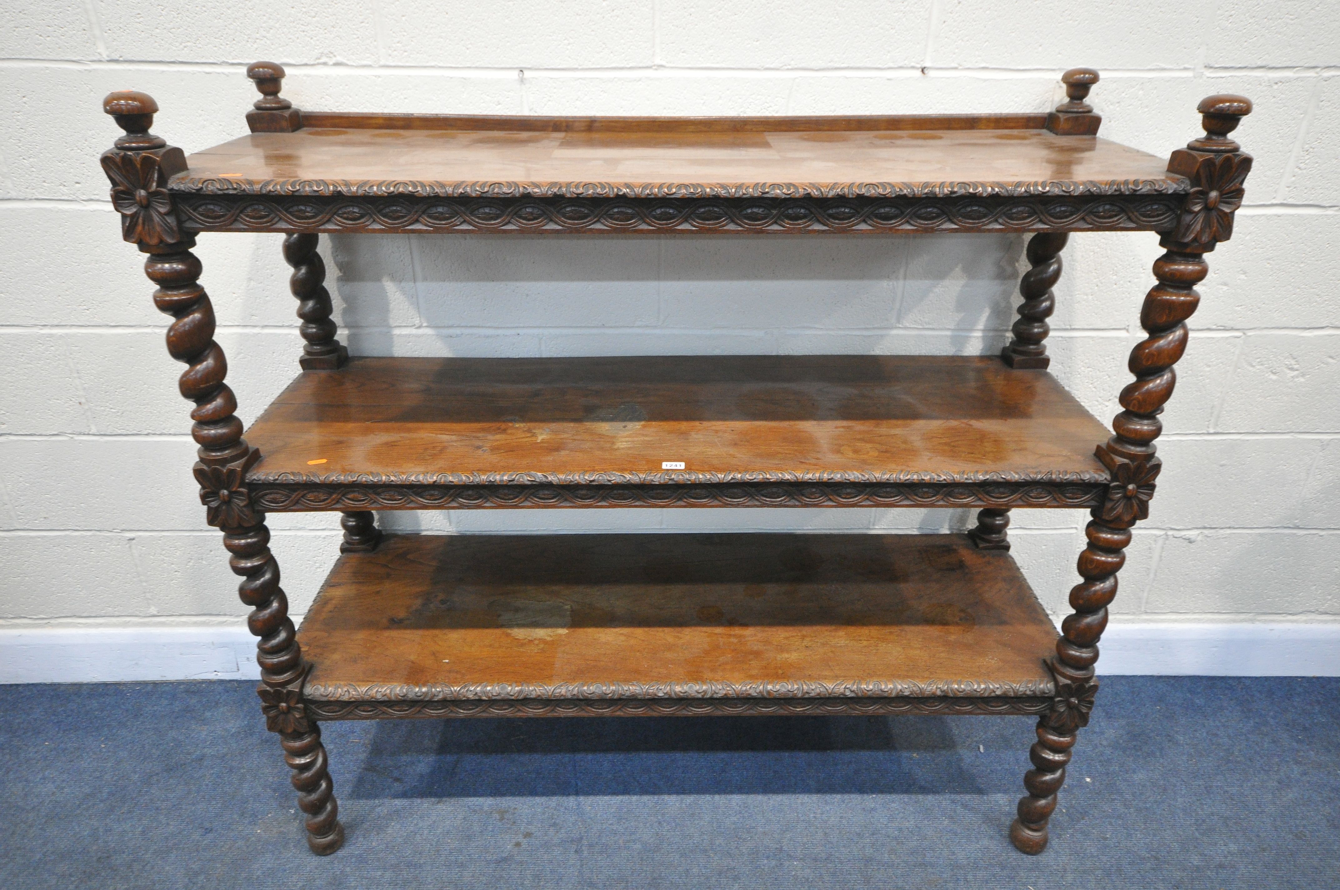 A LATE 19TH/EARLY 20TH CENTURY CARVED OAK THREE TIER BUFFET, on barley twist uprights, width 137cm x