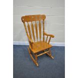 A MODERN BEECH ROCKING CHAIR (condition:-back left leg with a chip)