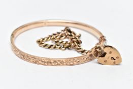 A HINGED BANGLE AND A CURB LINK BRACELET, the floral decorated rose gold tone, hinged bangle, fitted