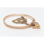 A HINGED BANGLE AND A CURB LINK BRACELET, the floral decorated rose gold tone, hinged bangle, fitted